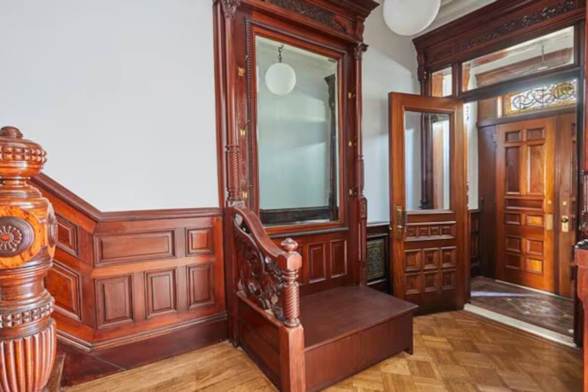 The entryway at 521 3rd Street has ornate wood railing.