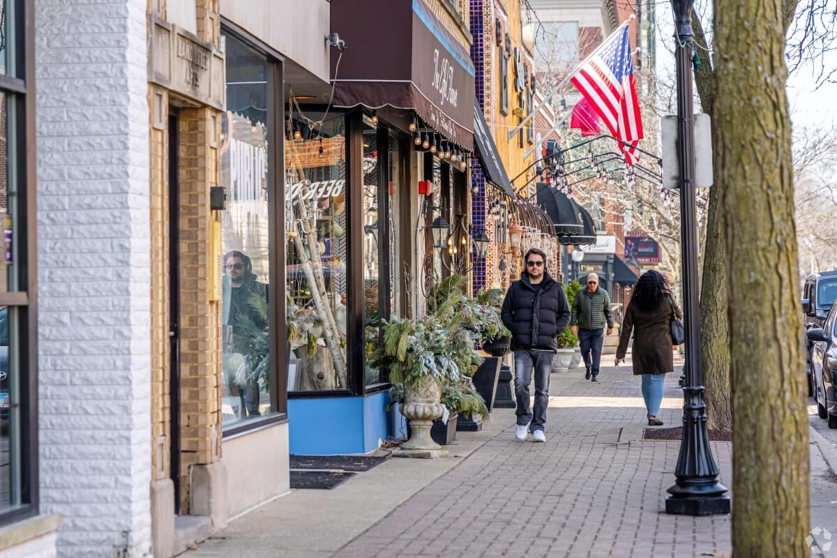 Residents walk past local shops and boutiques in Downtown Arlington Heights.