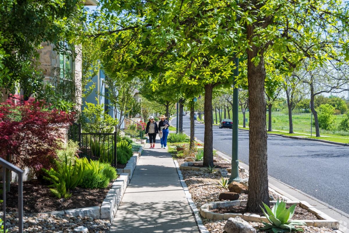 Pedestrians walk in Mueller in Austin, TX.