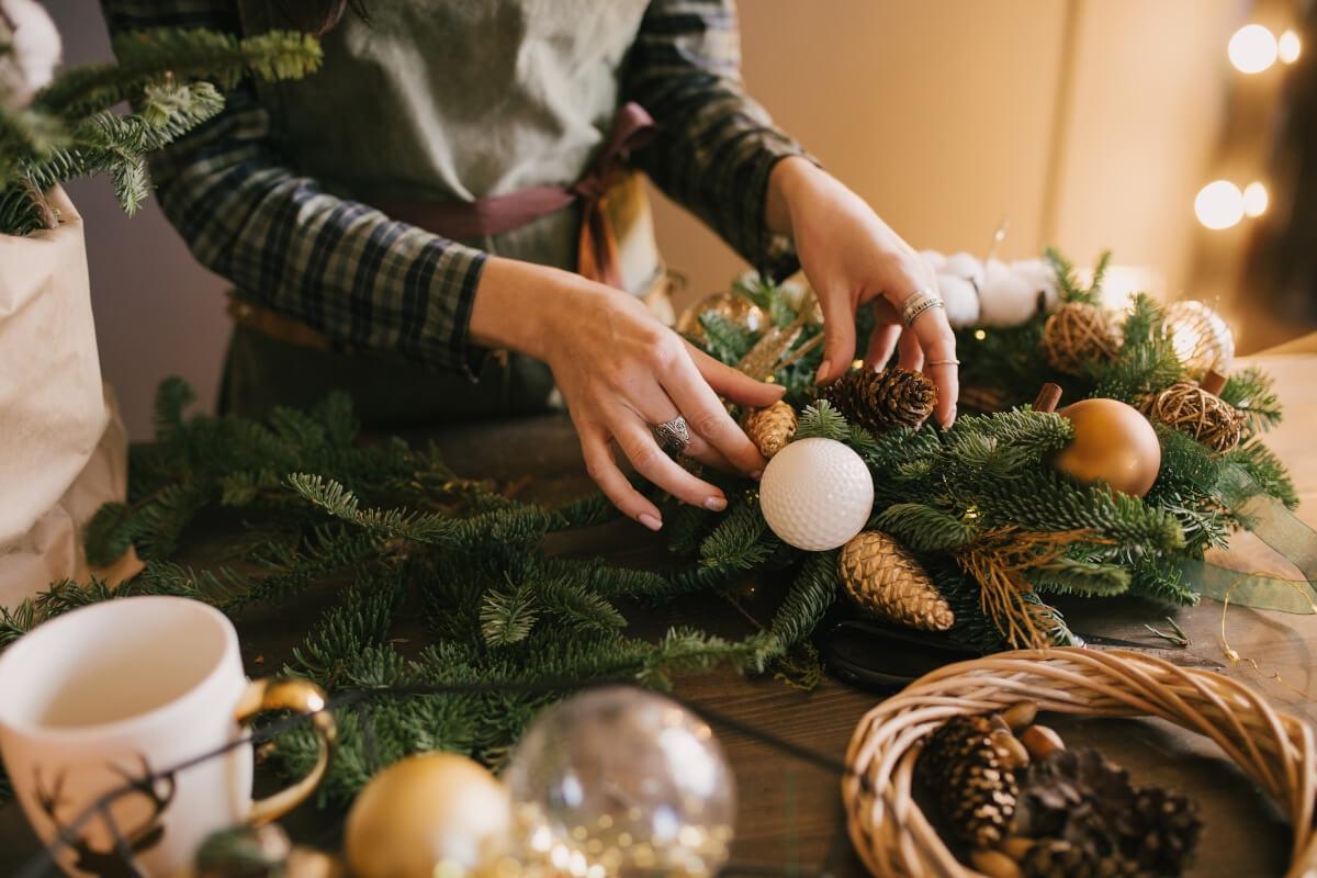 Person makes a DIY Christmas wreath.