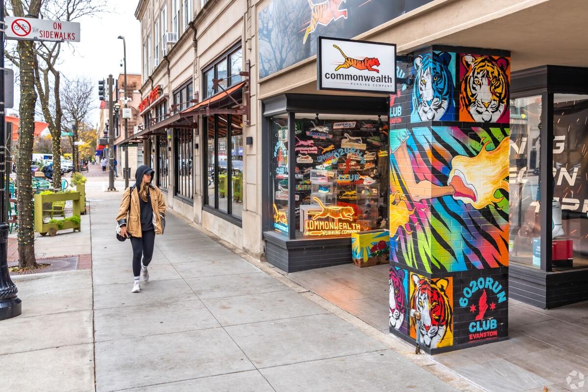 Woman looks at local shops as she walks past in Evanston.