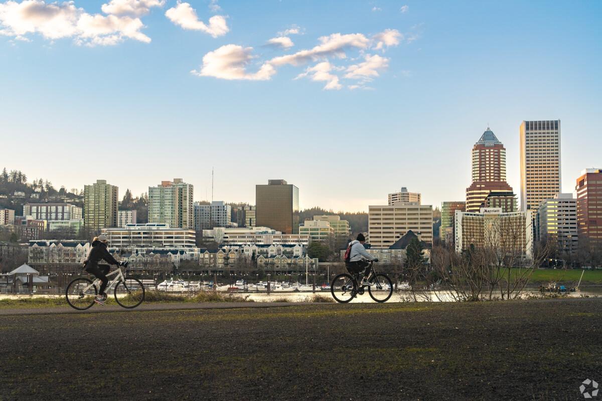 People biking along the river.