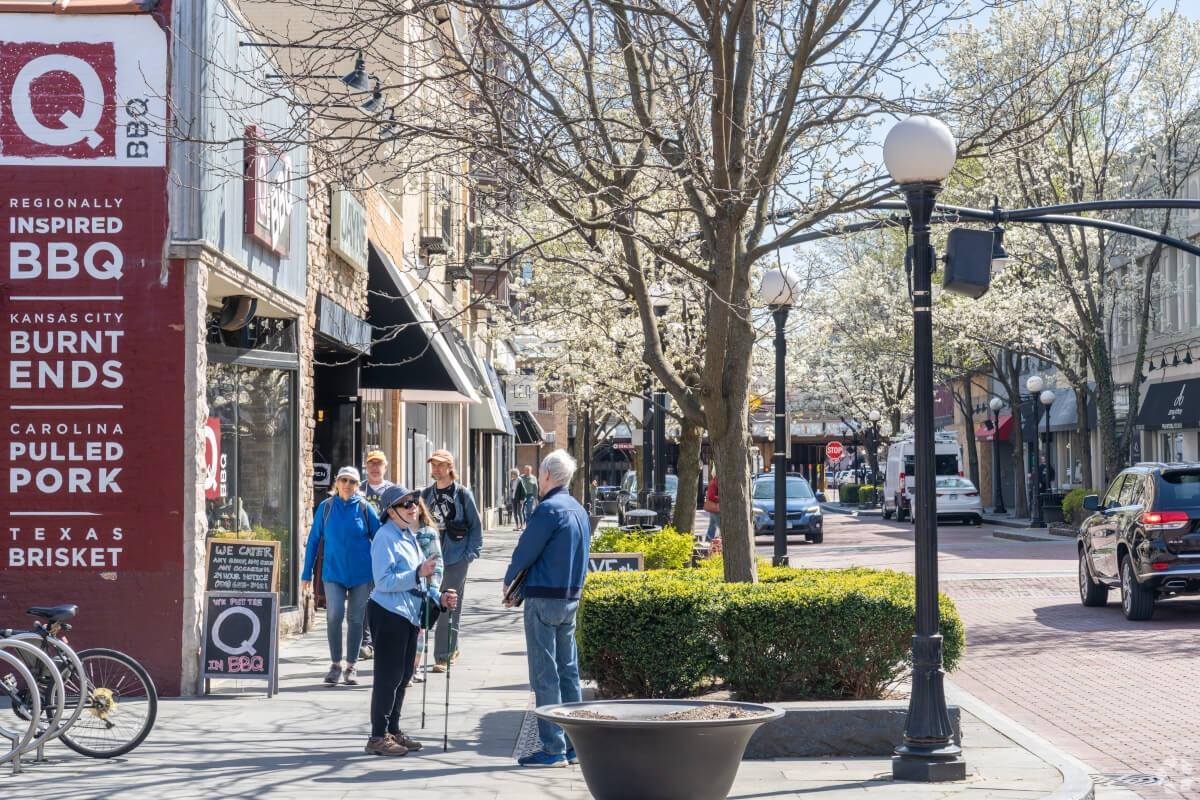 Residents chat on the sidewalk in front of local shops in Downtown Oak Park.
