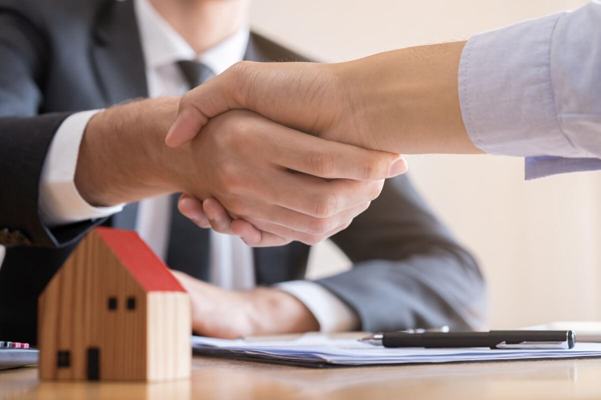 Landlord and tenant shake hands.