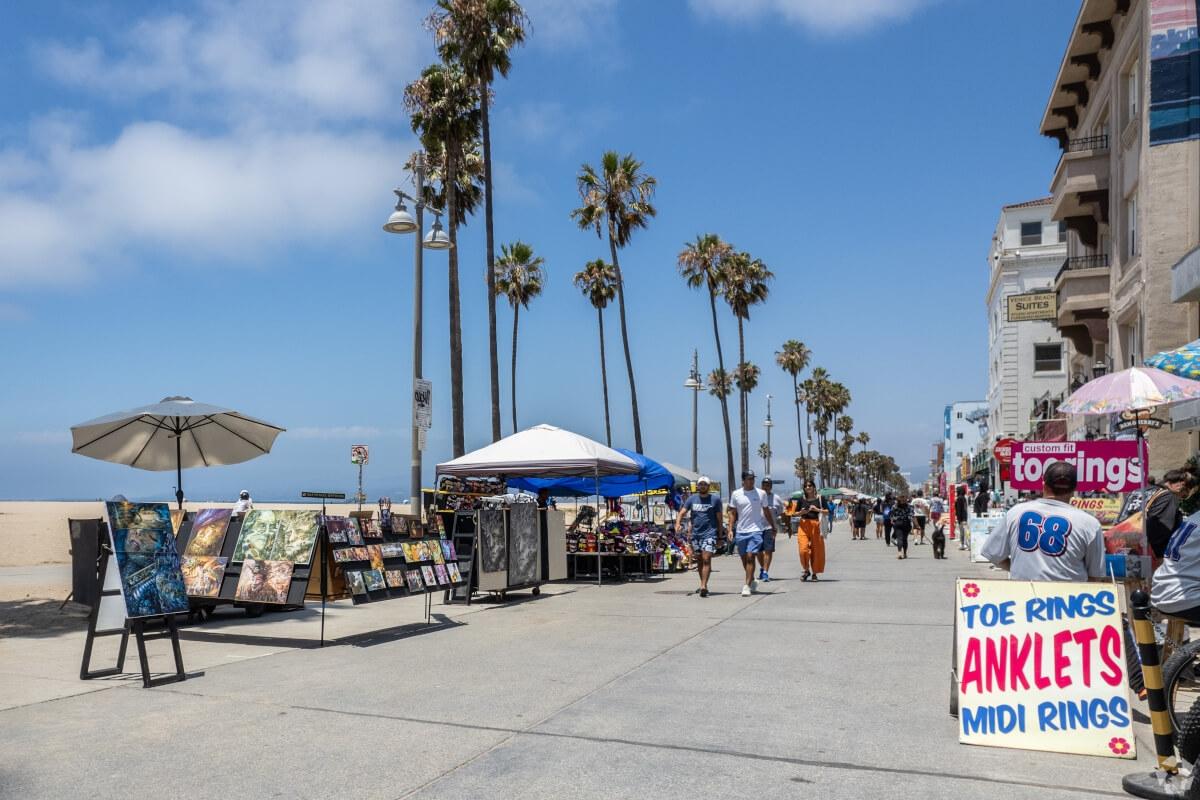 People walk on the Ocean Front Walk in Venice Beach.