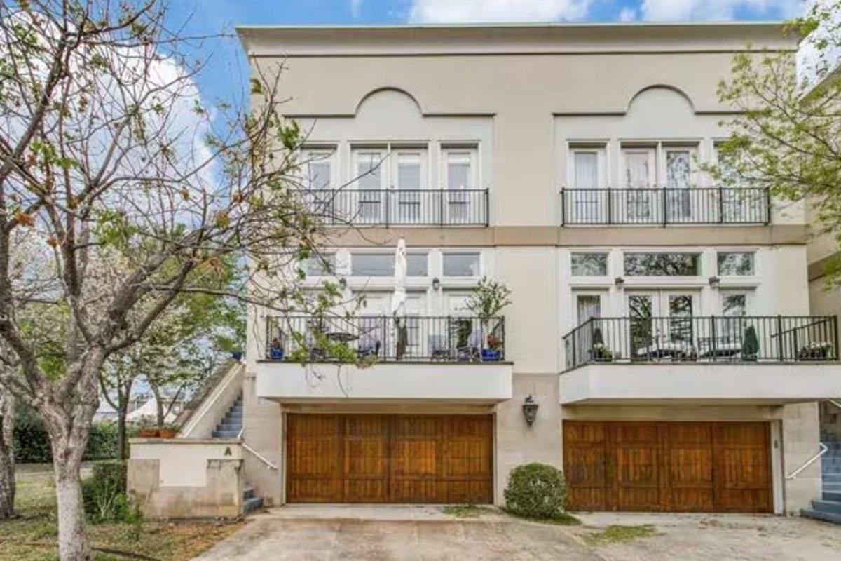 Two-story, white colored townhomes with wood-paneled garages