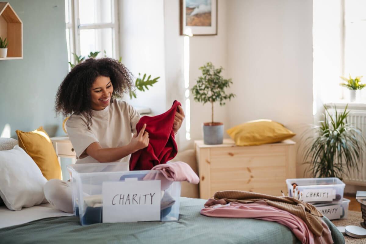 Woman declutters her bedroom.