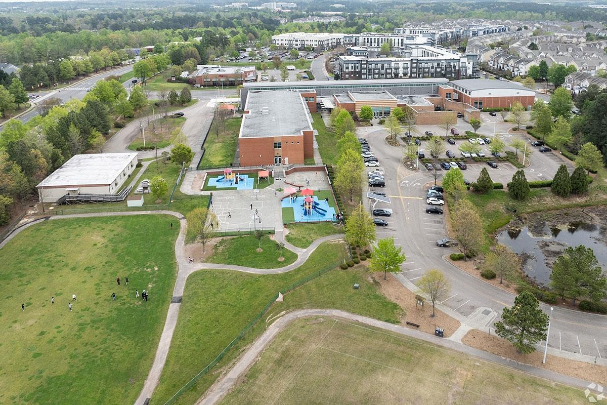 An school sits in front of apartment buildings and townhomes in Brier Creek.