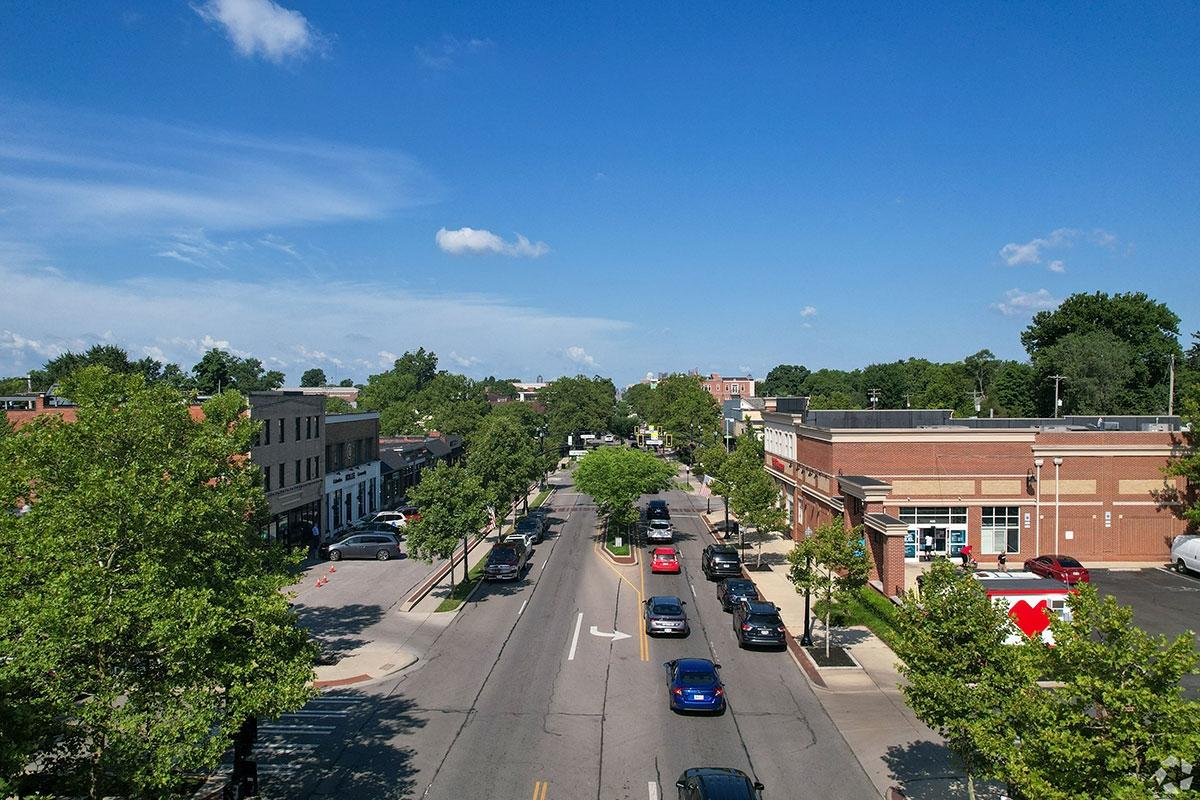 Cars drive down a main street in Bexley.