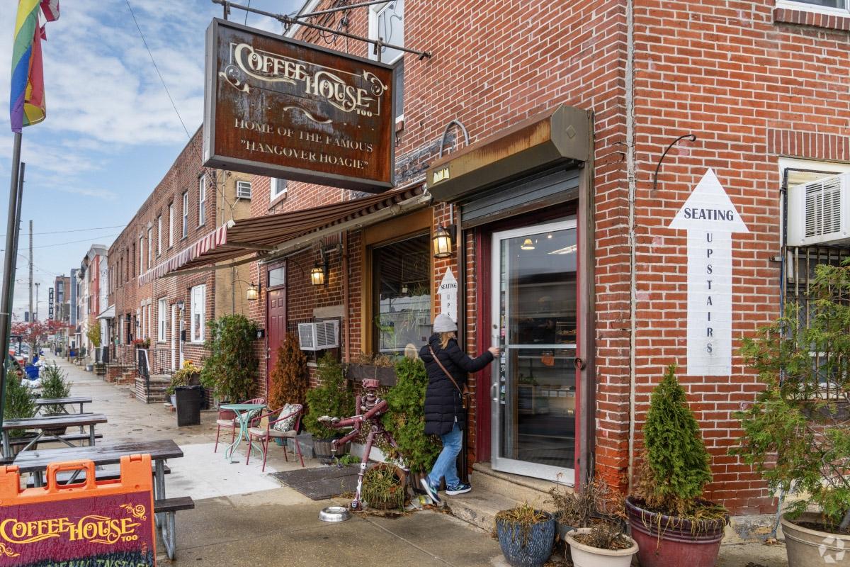 Brick storefronts on York Streets feature a coffee house and a Fishtown sign in the distance.