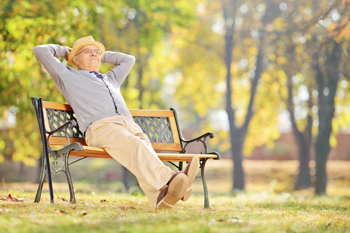 A senior gentleman on a park bench enjoying the sun
