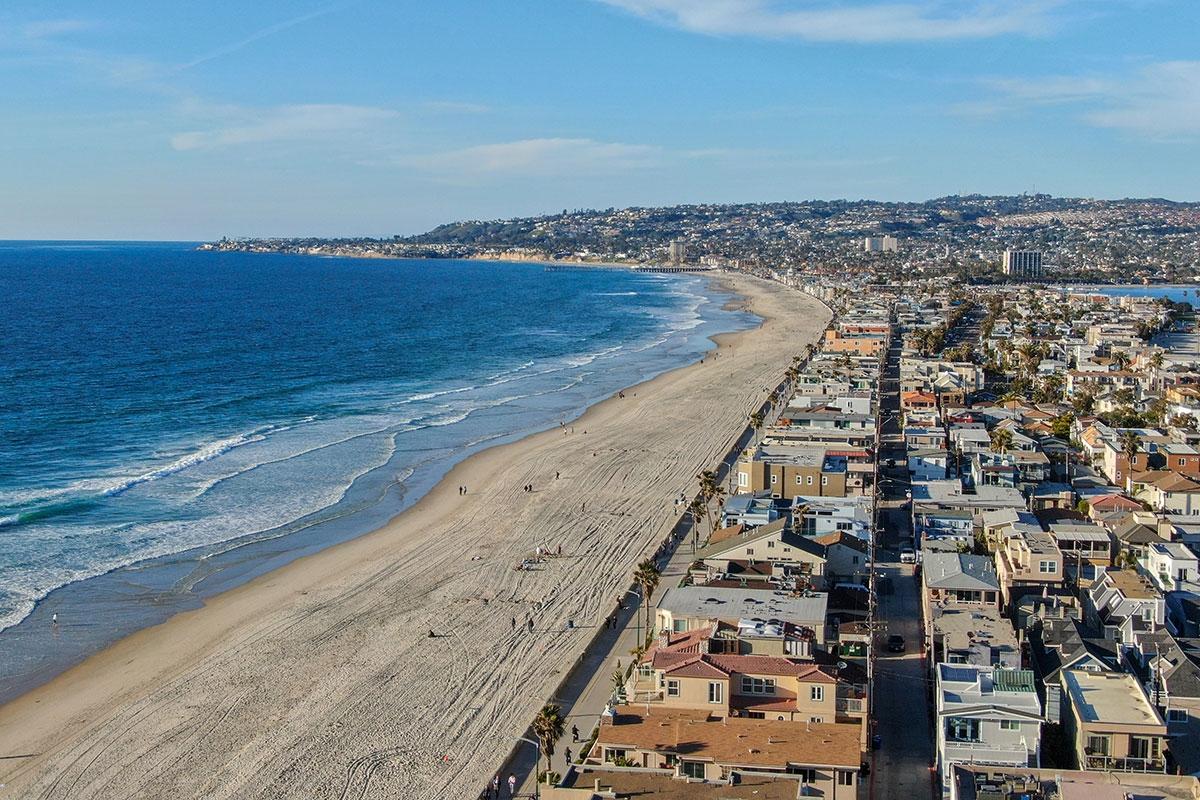 The beach of Pacific Beach stretches along the ocean.