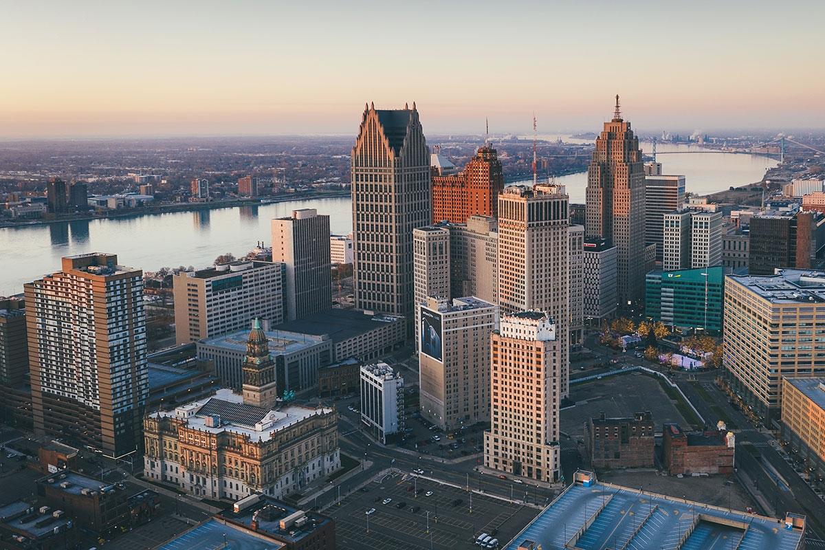 Detroit's downtown skyline rises over the river with Canada in the background.