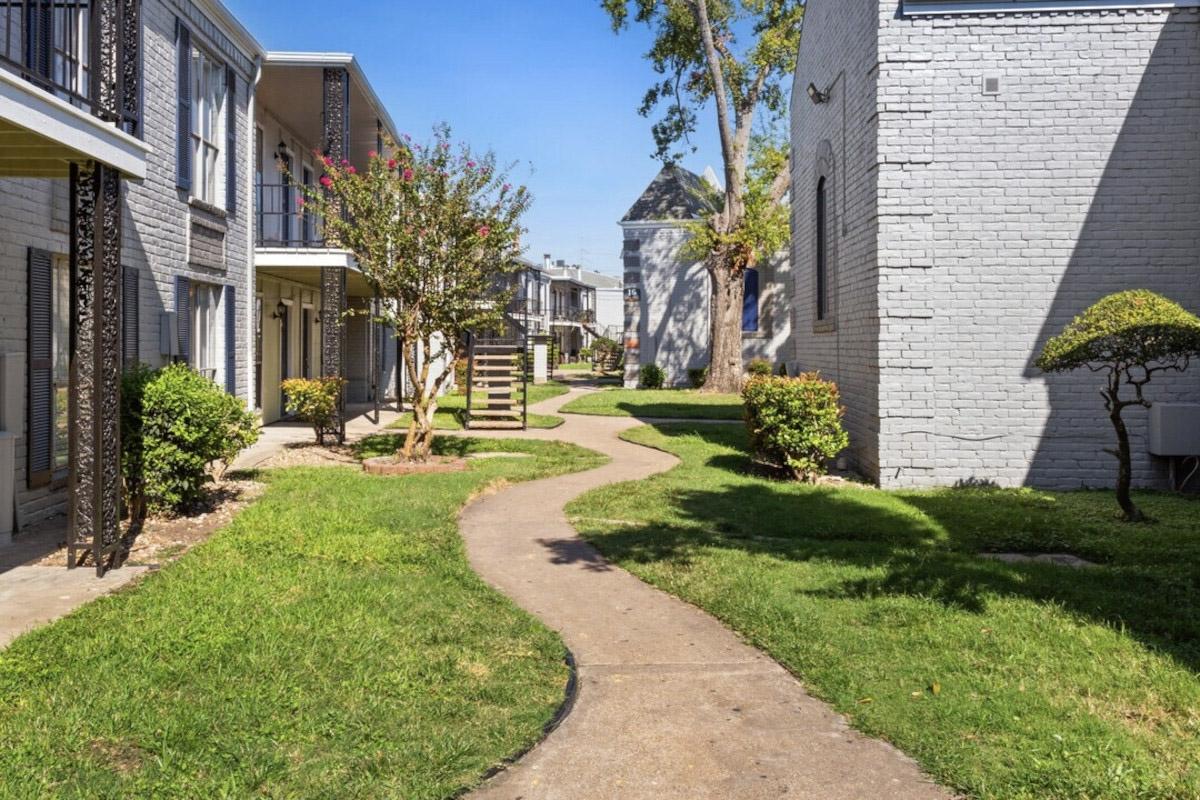 A sidewalk snakes between buildings at Town Park Apartments in Chinatown.