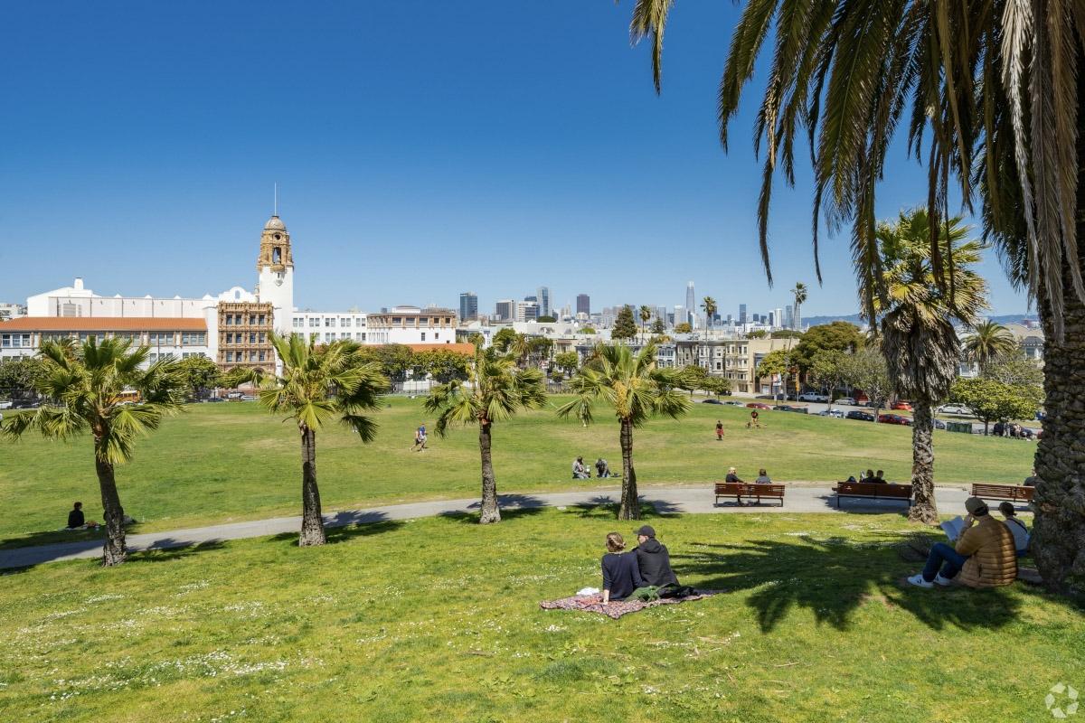 San Franciscans enjoy a sunny day at Mission Dolores Park.