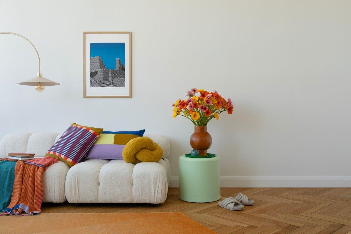 A colorful living room with fun pillows and whimsical furniture