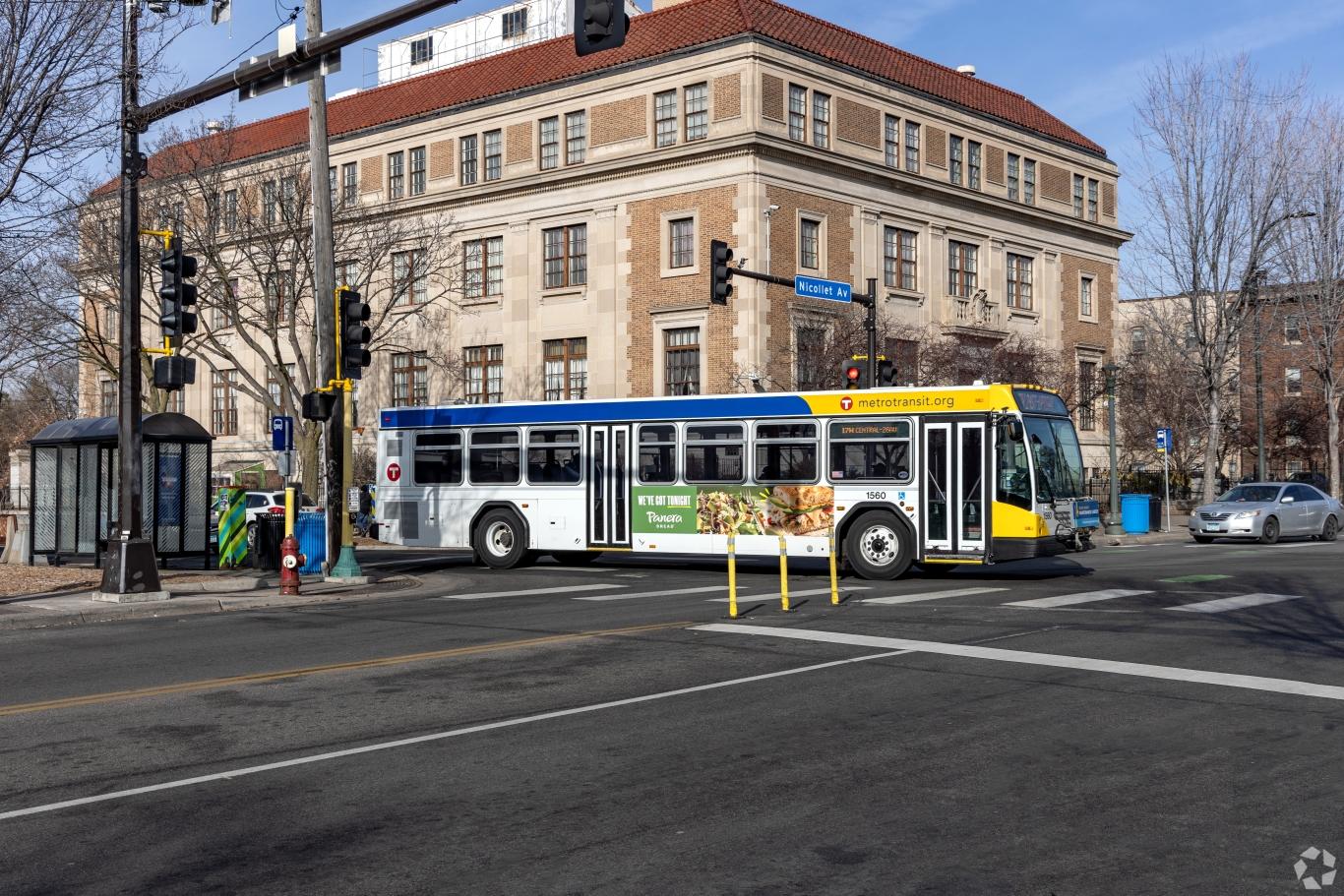 A main street in Stevens Square with a city bus on the corner