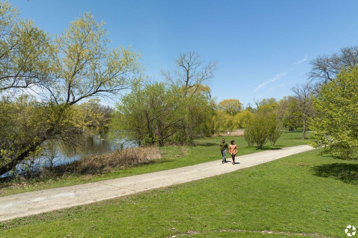 Couple on a stroll through a park on a sunny day