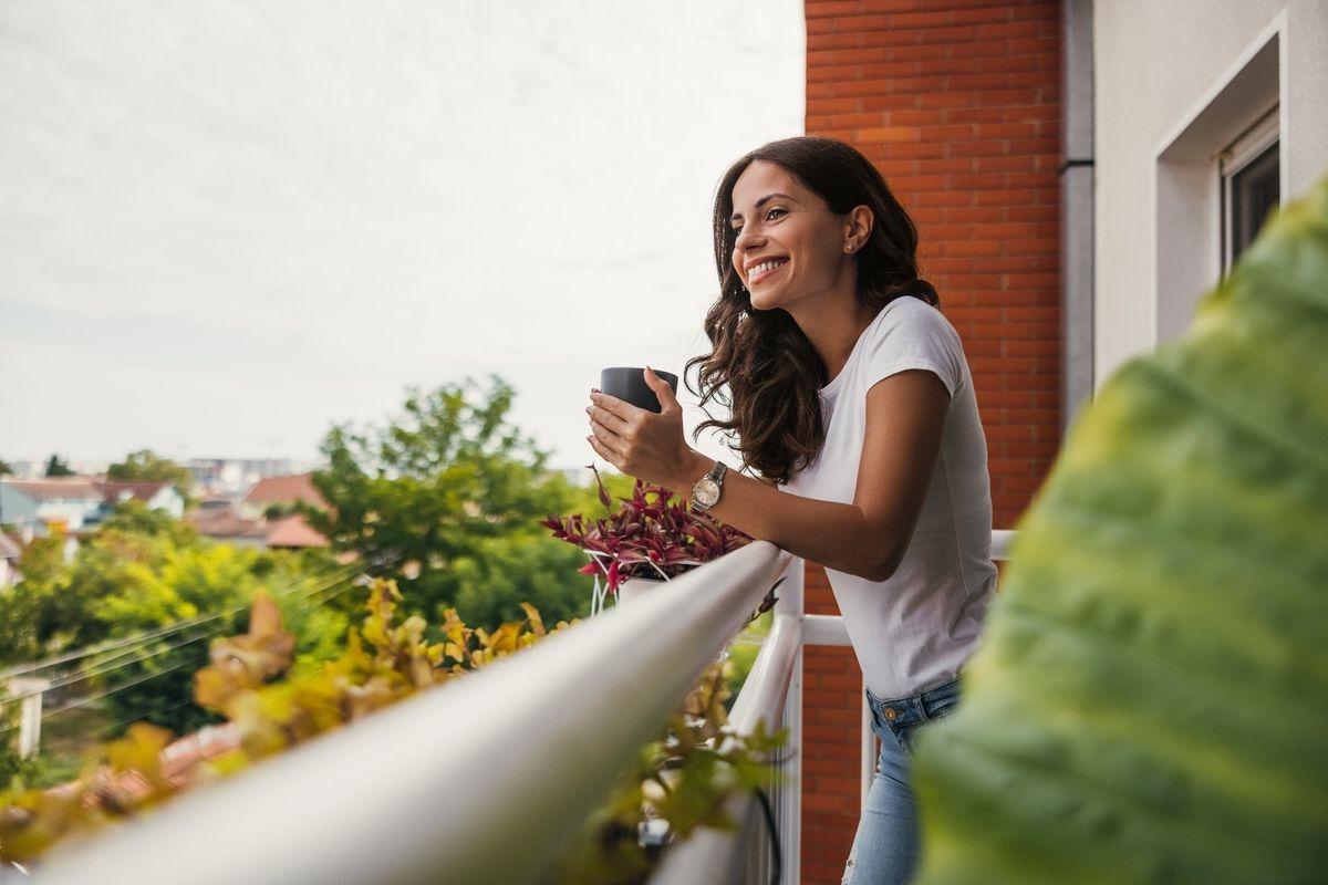A woman enjoying coffee on her private balcony