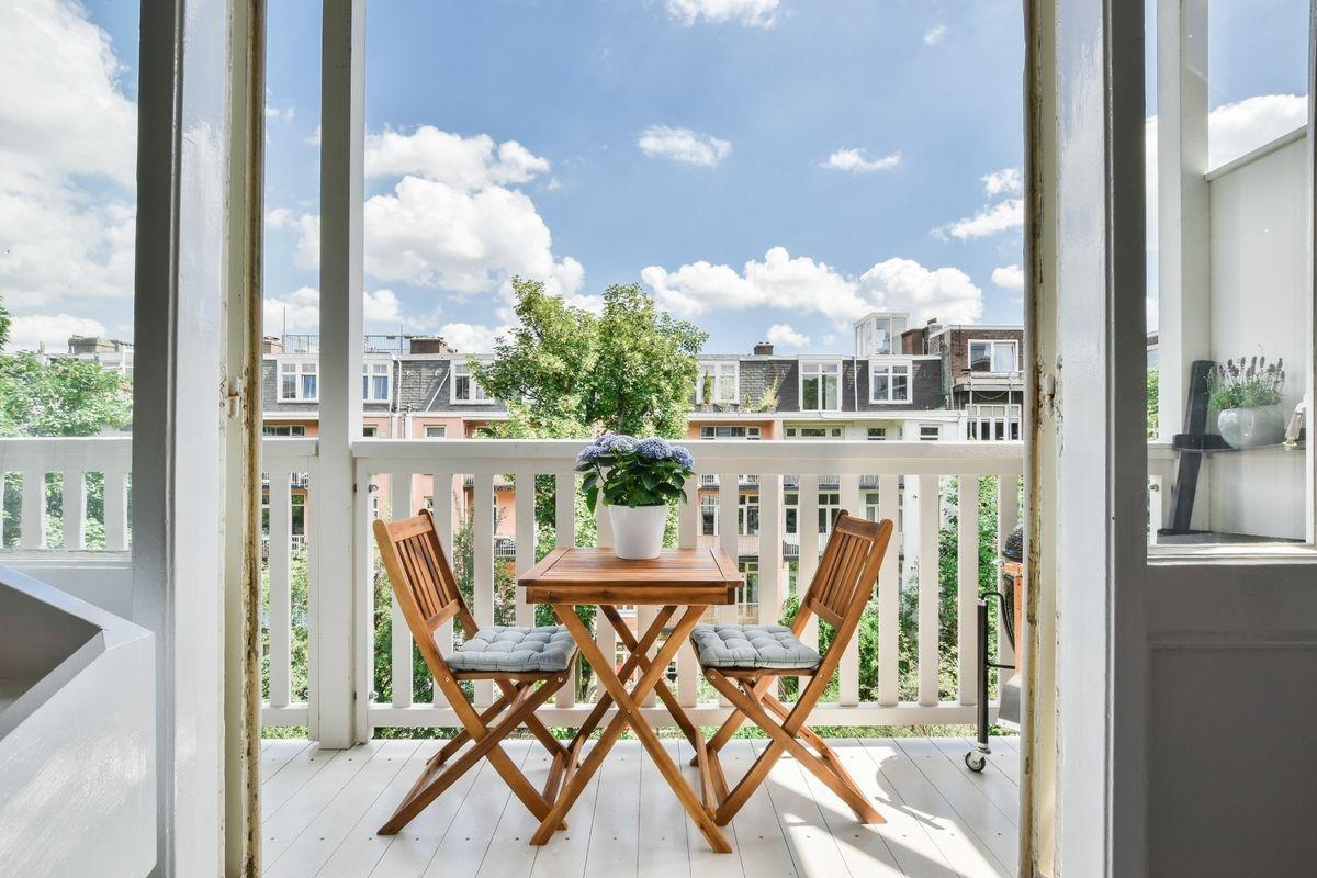 A folding dining set on a sunny balcony