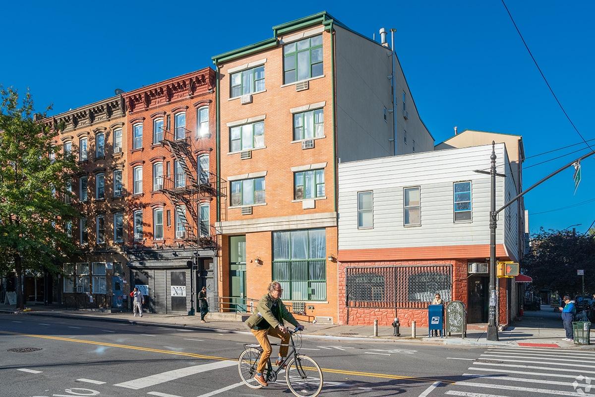 A person riding their bike on a quiet street in Greenpoint.