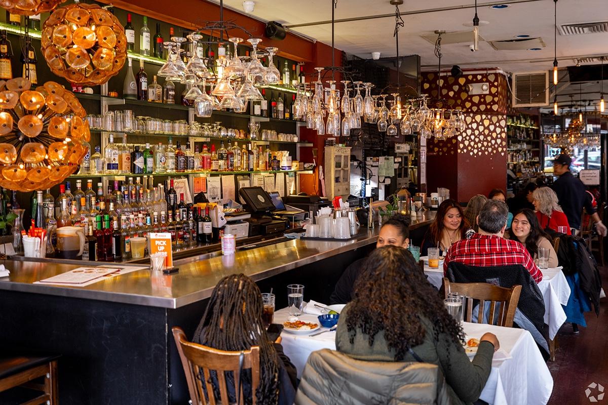 A restaurant is filled with people dining.