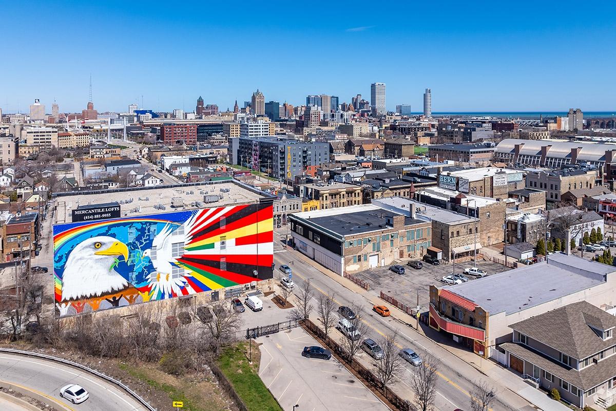 Walker's Point bustling streets and murals sit in a cluster as Historic Third Ward rises in the background.