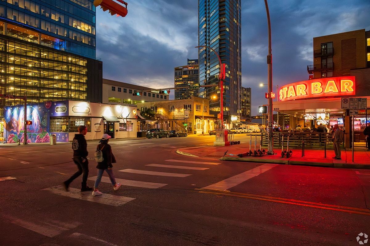 Residents walk across the street in Sixth Street District of Austin.