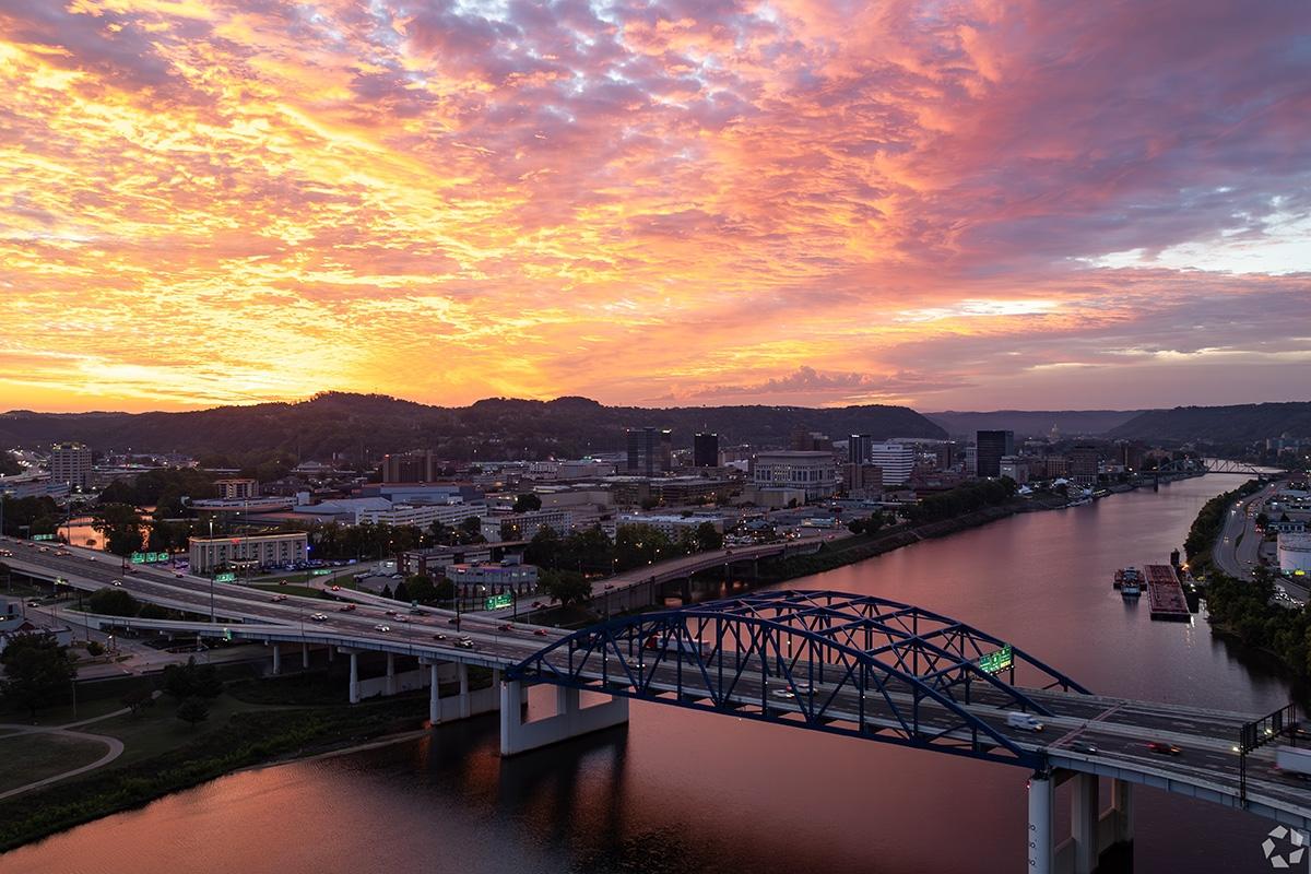 An aerial view of a bridge over the Kanawha River in Charleston, WV, at sunset.
