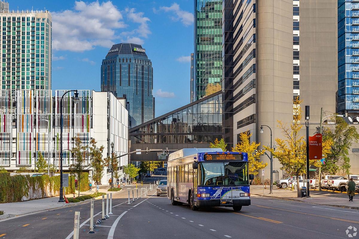 A bus driving on a downtown street in Nashville.