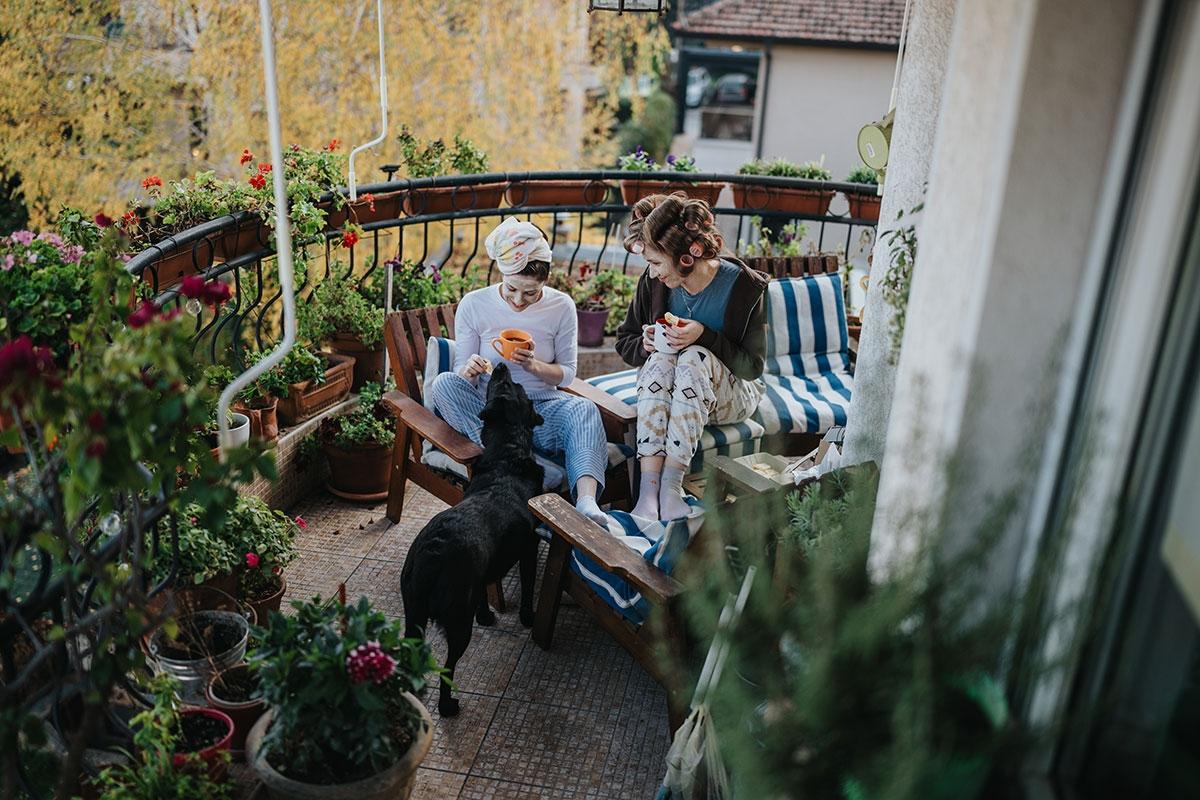 Renters sitting on their small apartment balcony.