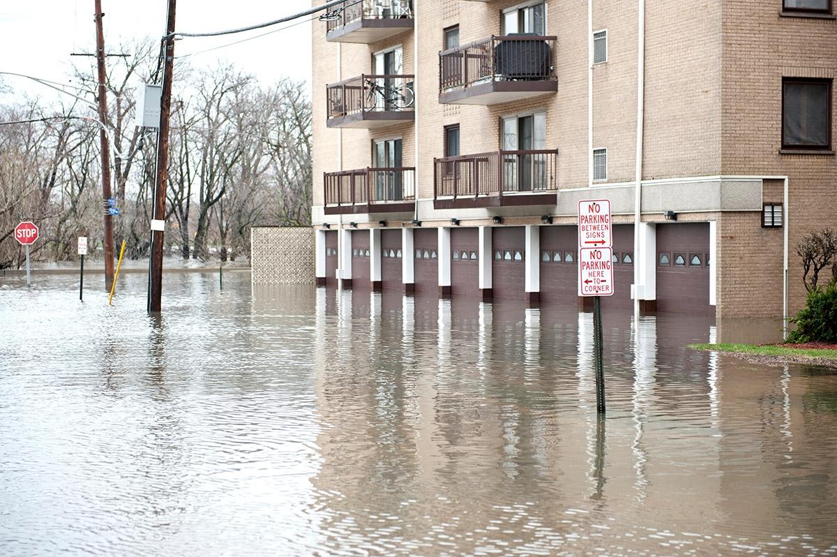 Flood waters as high as garage doors of an apartment community.