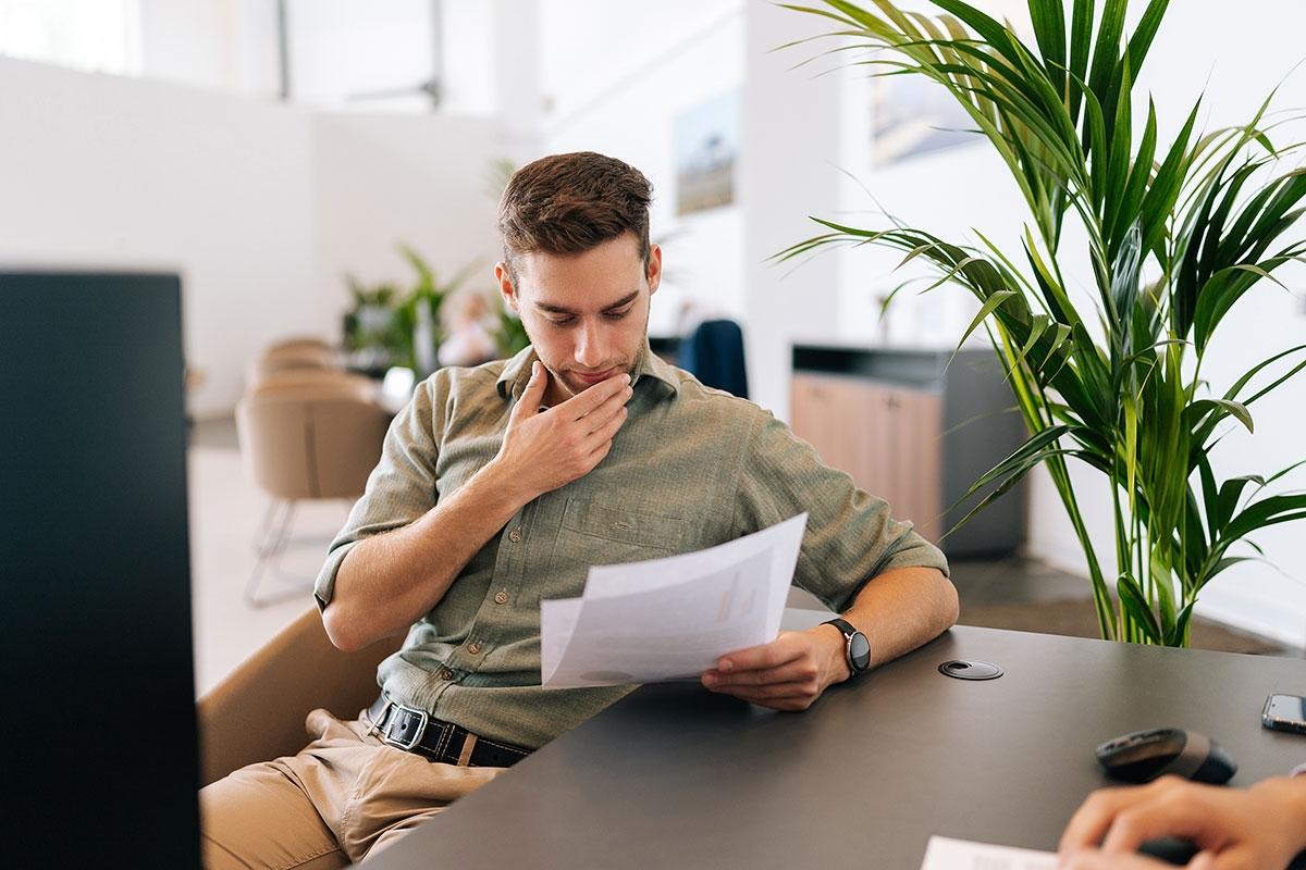 Landlord reading over a tenant's rental application.