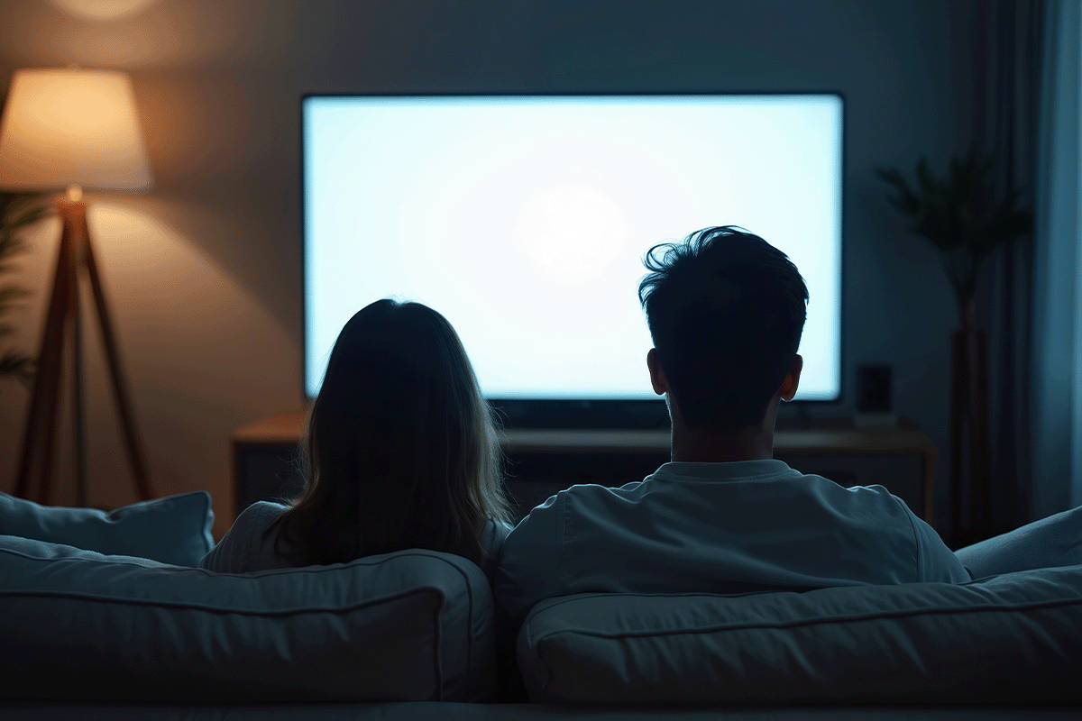 Couple watching tv in their apartment