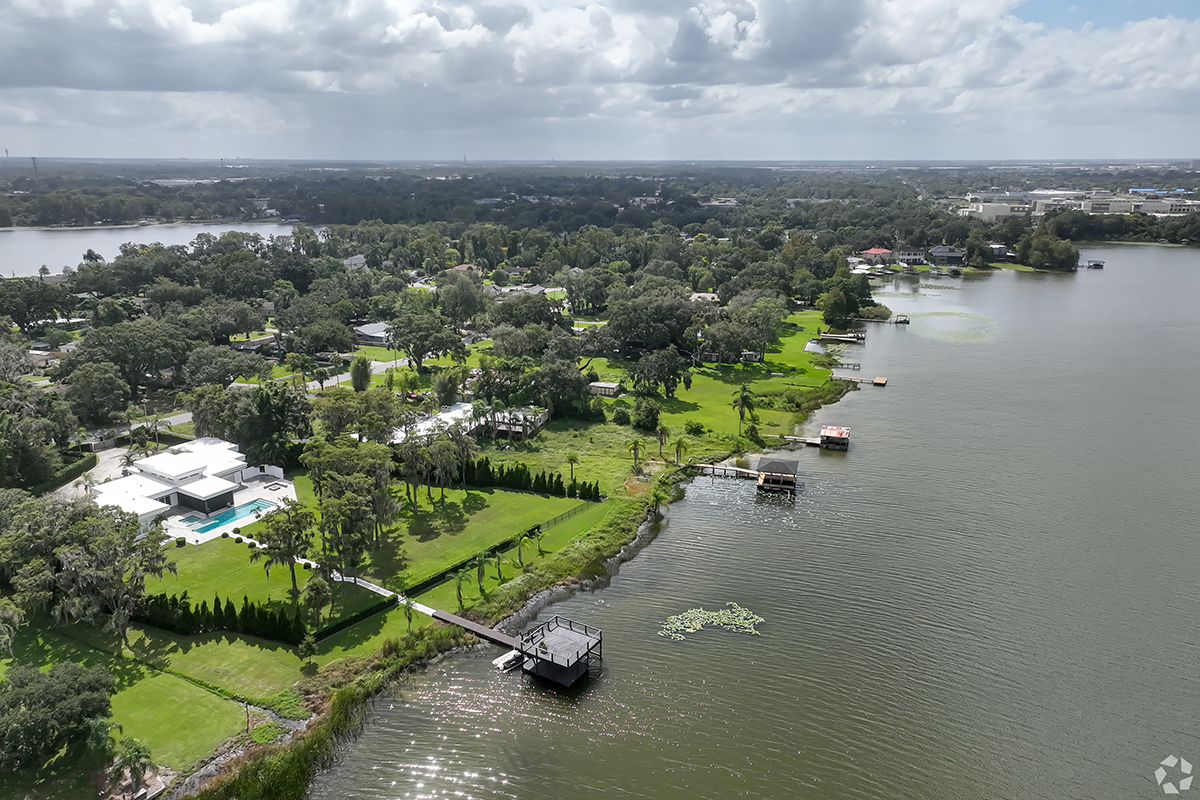 A beautiful view of lakefront homes on a sunny afternoon in Lake Jasmine.