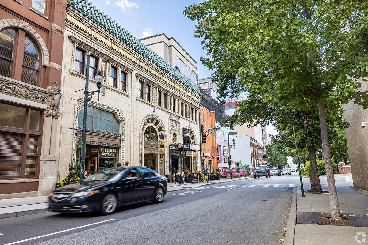 Asheville's streets are filled with beautiful classic buildings that people walk between.