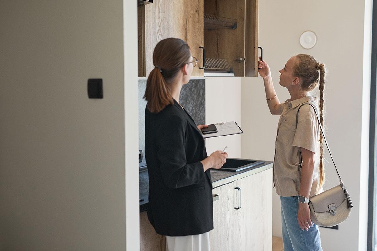 Student renter touring a college apartment.