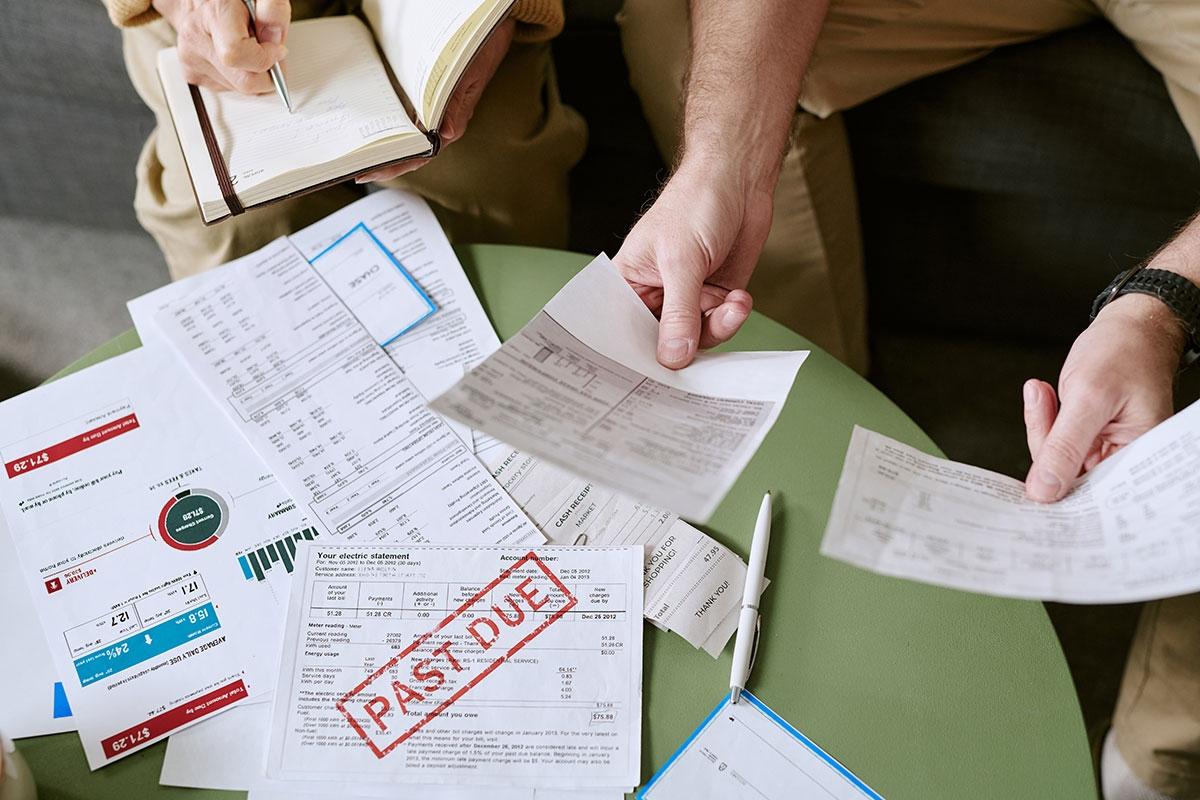 Landlords looking at past tenants' overdue utility bills. 