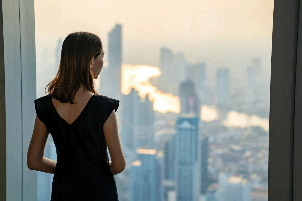 Gen Z Woman Looking Out a Window in New York City