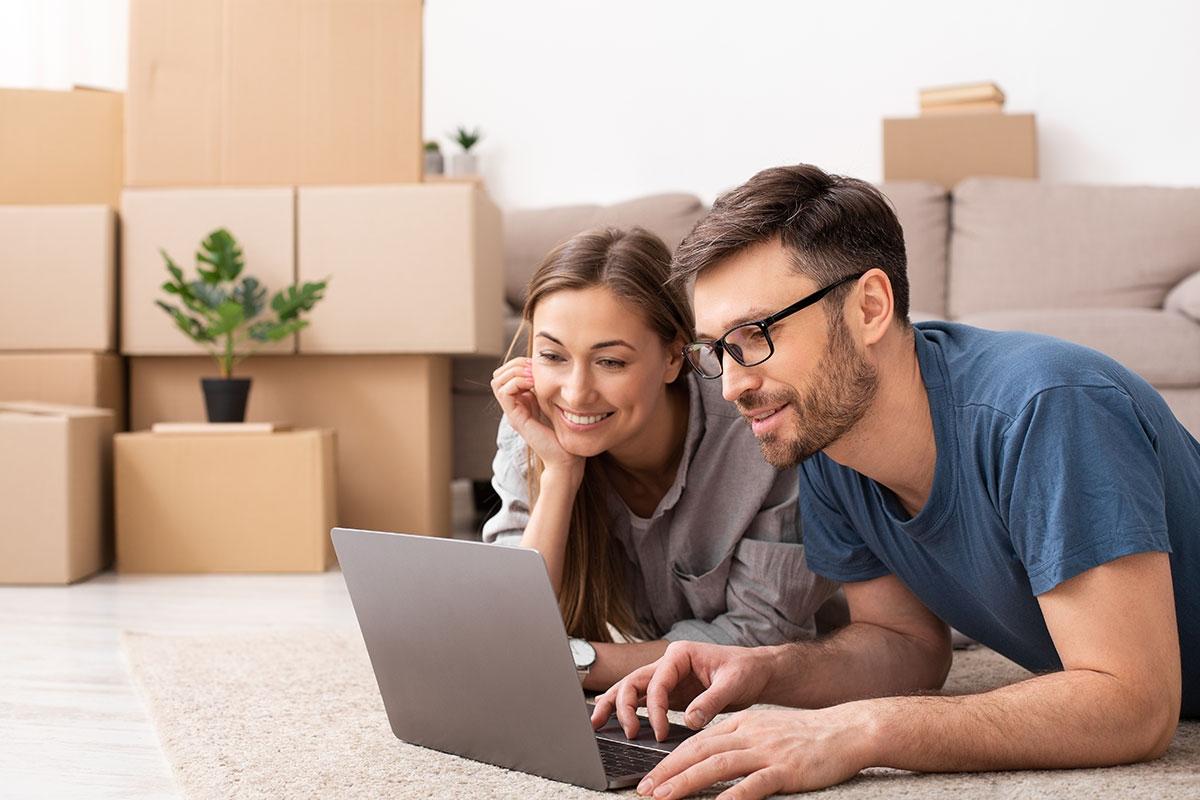 A renter couple searching for apartments online and looking at amenities.