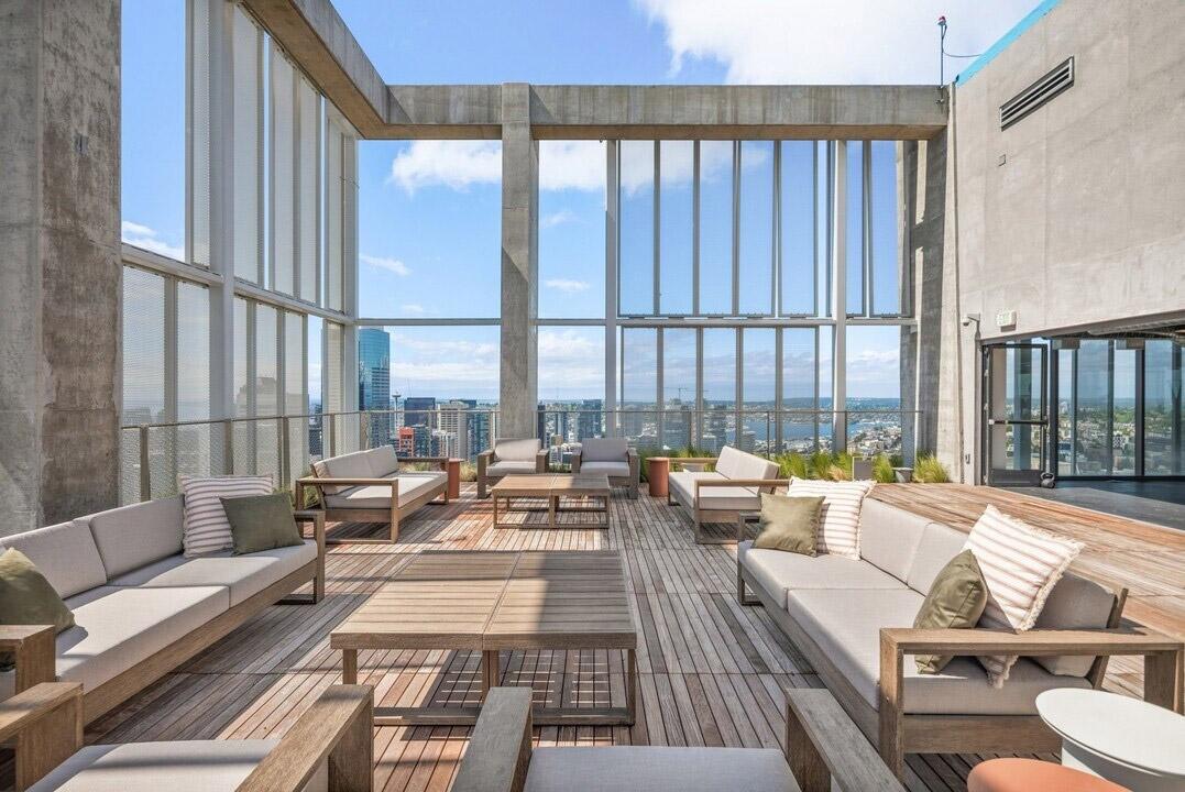 An outdoor patio has sky-high views of Puget Sound and the rest of Seattle in a luxury apartment community.