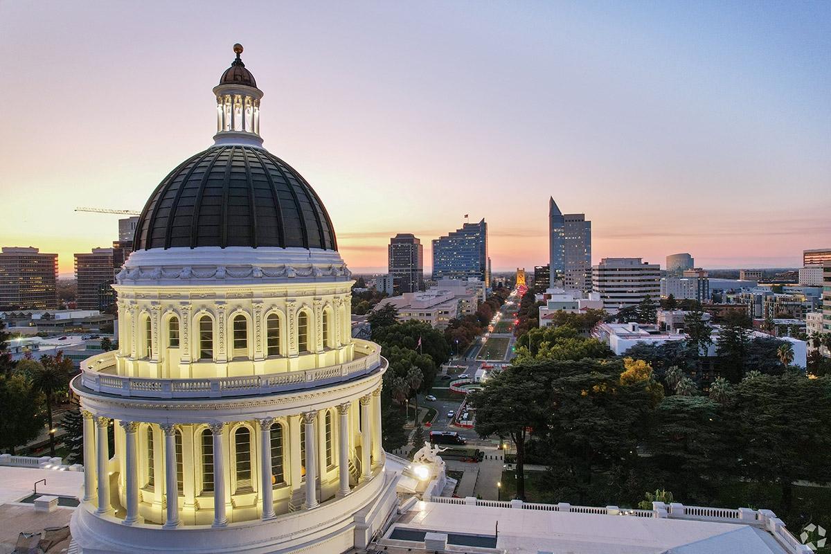 The California State Capital rises over Capitol Mall in Sacramento.