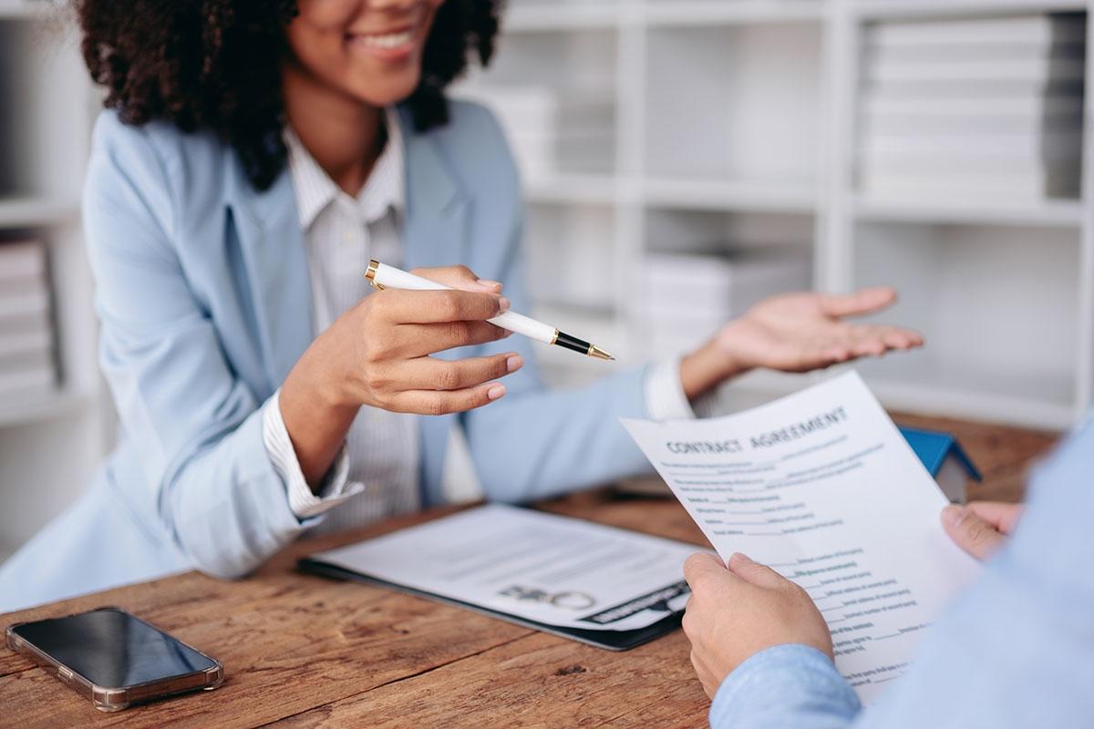 Photo of a leasing agent talking to a renter about a lease agreement.