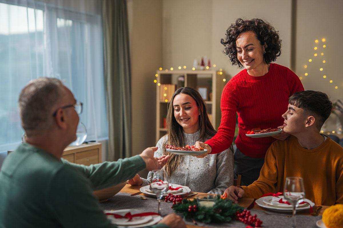 Woman hosting guests in her apartment for the holidays.