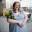 A professional image of Helen Ann Wells holding flowers. 