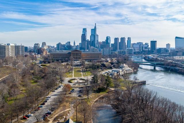 The Philadelphia skyline sits behind a view of the Schuylkill River and the Philadelphia Museum of Art.