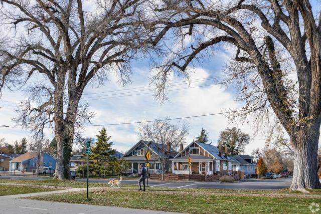 Tree-lined residential street in Salt Lake City’s Sugar House neighborhood, showcasing charming craftsman-style homes ideal for family living.