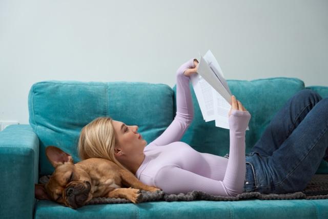 Tenant reviews her renters insurance policy while lounging on the couch. 