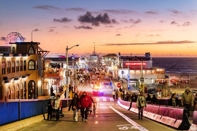 Santa Monica Pier is filled with people well into the evening.