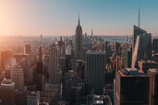 The skyline of New York rises during the sunrise.